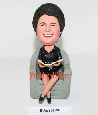 Lovely Mom Sitting on a Chair and Reading Newspaper Bobblehead