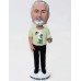 Bobblehead in Black Slacks and Yellow Shirt Holding a iPad
