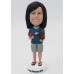 Woman Holding a Book and a Tomato Bobblehead Woman Holding a Book and a Tomato Bobblehead
