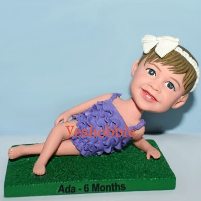 Little Girl Laying On The Grass Bobblehead Little Girl Laying On The Grass Bobblehead